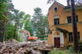 Obninsk, Russia - July 2018: Demolition with an excavator of an old brick building in Obninsk