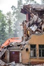 Obninsk, Russia - July 2018: Demolition with an excavator of an old brick building in Obninsk