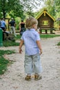 2010.08.15, Obninsk, Russia. Little boy running and jumping by the playground in the park.