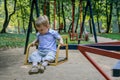 2010.08.15, Obninsk, Russia. A little boy spinning on a carousel and laughing. Happy childhood close up.