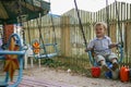 2010.08.15, Obninsk, Russia. A little boy spinning on a carousel and laughing. Happy childhood close up.