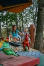 2010.08.15, Obninsk, Russia. A mother and a little boy spinning on a carousel horse and laughing.