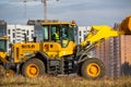 Obninsk, Russia - October 2019: Powerful excavators with raised buckets at a construction site