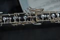 Oboe musical instrument resting on a score The oboe has a black body with silver keys, made of grenadilla wood Royalty Free Stock Photo