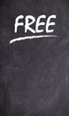 Illustration of a black chalkboard with the phrase Free written on it in white chalk. Free stuff poster. Royalty Free Stock Photo