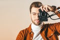 obscured view of handsome man taking picture on photo camera Royalty Free Stock Photo