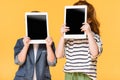 obscured view of kids holding tablets with blank screens
