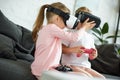 obscured view of kids in virtual reality headsets playing video game on sofa Royalty Free Stock Photo