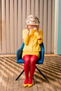 obscured view of woman in retro clothing holding golden fish in aquarium at colorful apartment doll Royalty Free Stock Photo