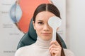 obscured view of young female patient getting eye test