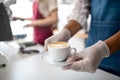 Obscured waiter serving coffee in cafe, small business, coronavirus and new normal concept. Royalty Free Stock Photo