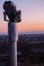 Observation deck and binoculars with a view of the city. Coin operated telescope binocular for sightseeing. Sunset above the city Royalty Free Stock Photo