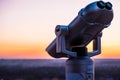 Observation deck and binoculars with a view of the city. Coin operated telescope binocular for sightseeing. Sunset above the city Royalty Free Stock Photo