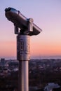 Observation deck and binoculars with a view of the city. Coin operated telescope binocular for sightseeing. Sunset above the city Royalty Free Stock Photo