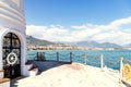 Observation deck near white lighthouse in Alanya, Turkey. Panoramic view of city, sea and harbour under cloudy sky. Selective Royalty Free Stock Photo