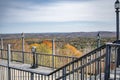 Observation deck with stationary coin binoculars overlooking the hills overgrown with autumn maples in Vermont