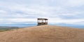 Observation deck. Wooden gazebo on the high point of Olkhon Island, in cloudy weather against the backdrop of mountains and the Royalty Free Stock Photo