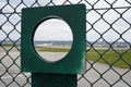 Observation hole in the fence around Zurich airport in Switzerland. Royalty Free Stock Photo