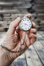 Adult man holding an antique pocket watch in his hand Royalty Free Stock Photo