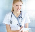 Observing your health. Portrait of a smiling nurse writing notes in her notepad. Royalty Free Stock Photo