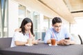 Obsessed Couple Using Smartphones In Shopping Mall