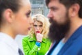 Obsessed ex girlfriend spying to a couple dating. She is obviously jealous. Bearded man cheating his girlfriend with Royalty Free Stock Photo