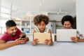 Obsessed to tech devices happy african american family using digital tablet, computer, smartphones.