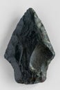 Obsidian arrowhead on white background Royalty Free Stock Photo
