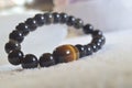 obsidian and tiger eye stone bracelet On selenite stone . Royalty Free Stock Photo