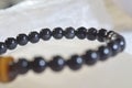 obsidian and tiger eye stone bracelet On selenite stone . Royalty Free Stock Photo