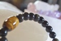 obsidian and tiger eye stone bracelet On selenite stone . Royalty Free Stock Photo