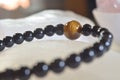 obsidian and tiger eye stone bracelet On selenite stone . Royalty Free Stock Photo