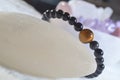 obsidian and tiger eye stone bracelet On selenite stone . Royalty Free Stock Photo