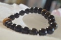 obsidian and tiger eye stone bracelet On selenite stone . Royalty Free Stock Photo