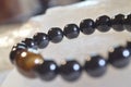 obsidian and tiger eye stone bracelet On selenite stone . Royalty Free Stock Photo