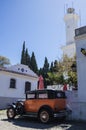 Obsolete car, in front of the lighthouse of Colonia del Sacramento, Uruguay. It is one of the oldest cities in Uruguay Royalty Free Stock Photo