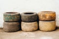 obsolete car tires on a white wall background, old and used, road safety concept