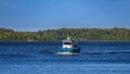 Obsolete local public transport waterbus sailing along coastline of islands in Gulf of Finland near to Vyborg