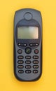 Obsolete mobile phone on a yellow background Royalty Free Stock Photo