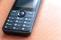 Obsolete new push-button phone on the table, impossible to crack