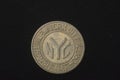An obsolete New York City subway token