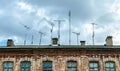 Obsolete rusty television antennas on the roof of an old house. Analog technology