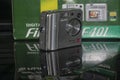 An obsolete and unusable slim and ultra-compact Fuji FinePix F401 camera with all its accessories and manual pile up to be trash o Royalty Free Stock Photo