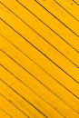 Obsolete yellow painted wooden background texture. Outdoor, macro