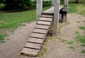 Wooden natural climbing frame obstacle for dog training canine meadow footbridge meter high from the ground, around lawn