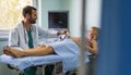 Obstetrician examining pregnant woman belly by ultrasonic scan in hospital. Royalty Free Stock Photo