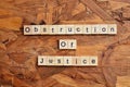 Obstruction of justice text on wooden square, law quotes