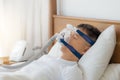 Obstructive sleep apnea therapy, Man wearing CPAP mask.