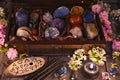 Box with magic crystals and stones, black candle and spring flowers Royalty Free Stock Photo