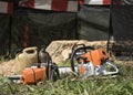Occupation: Closeup of chainsaws in front of a tree stump.